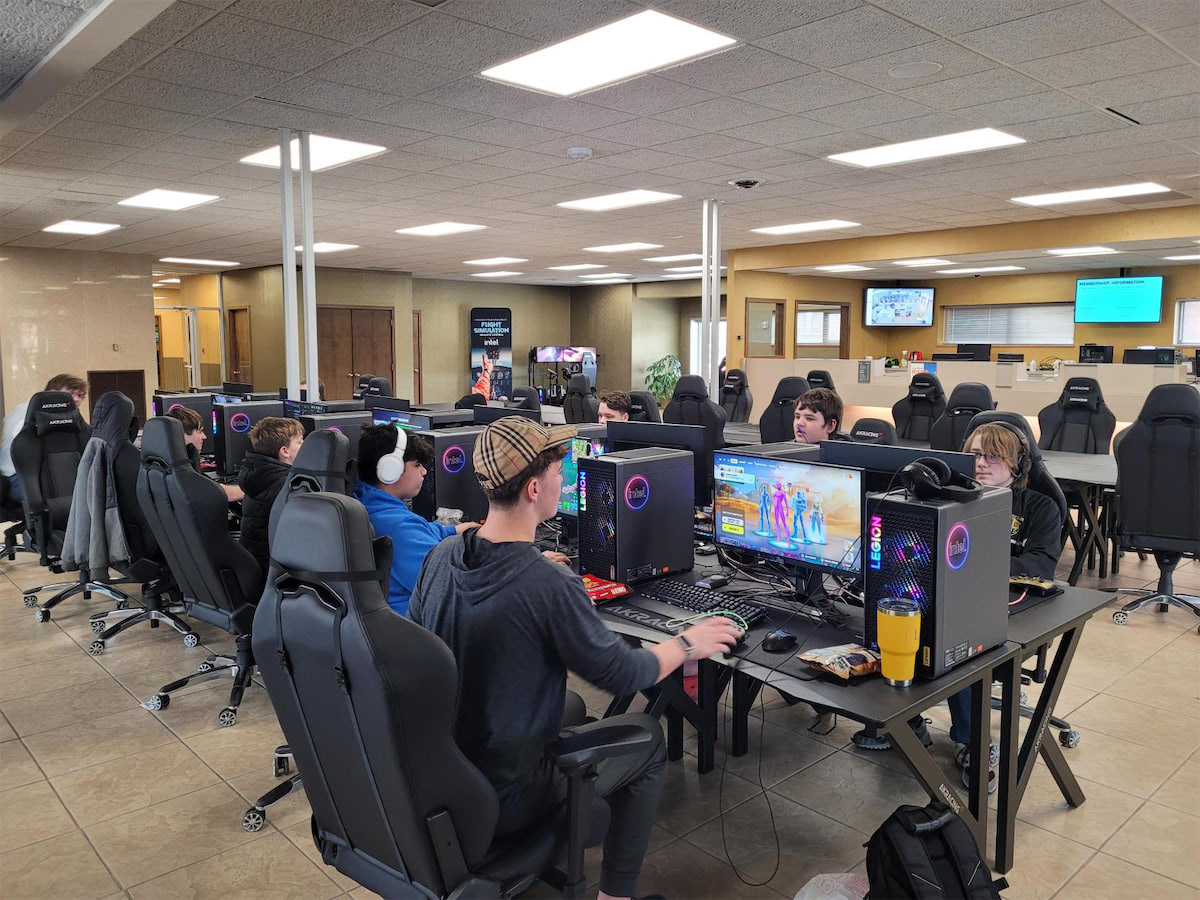 Two people playing games on computers